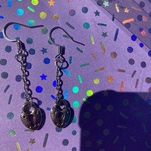 Silver locked heart long dangling earring.